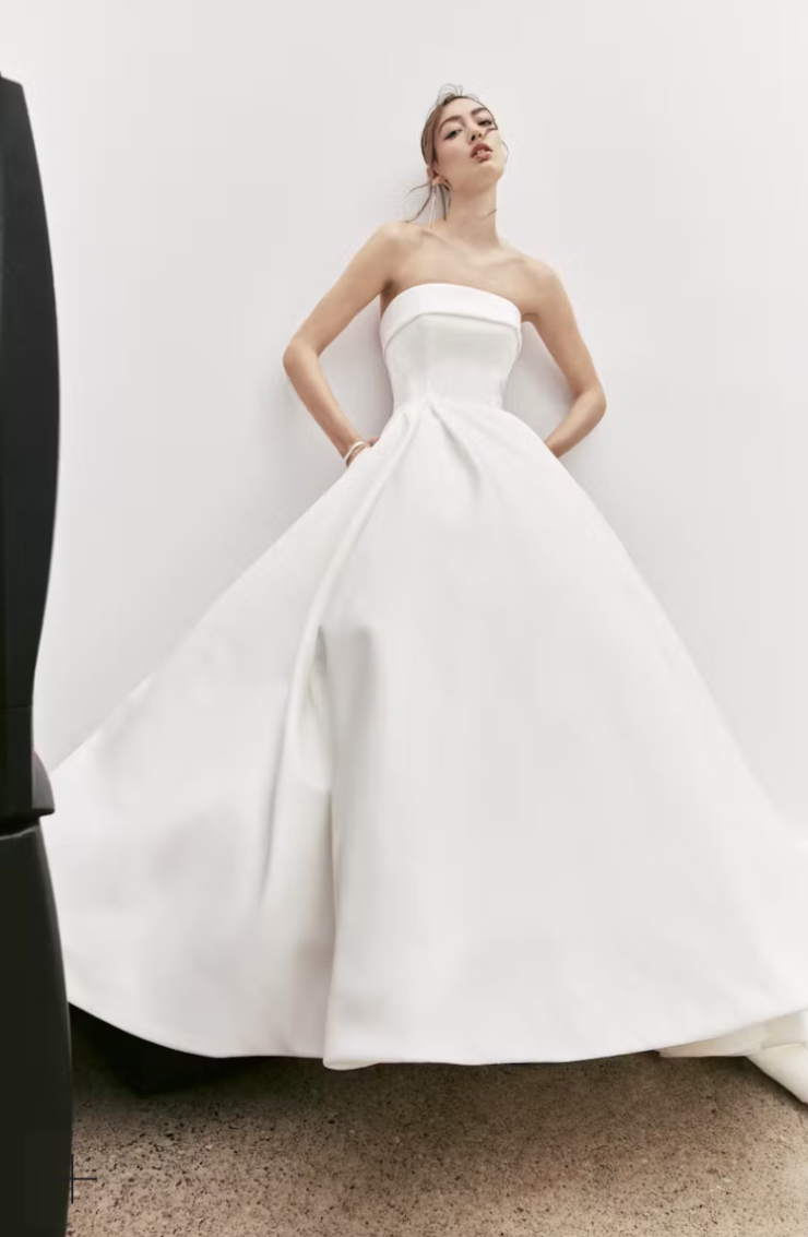 Banded strapless ballgown with back cutout, accented with bow